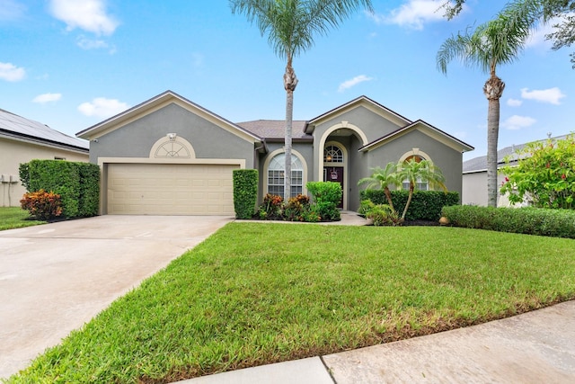 ranch-style house featuring concrete driveway, a garage, stucco siding, and a front yard