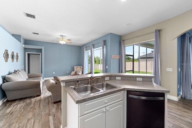 2808 Abbey Grove Dr, Valrico, FL 33594 - kitchen featuring dishwashing machine, open floor plan, light wood finished floors, a ceiling fan, and white cabinets