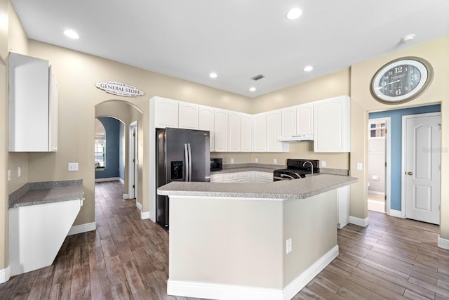 2808 Abbey Grove Dr, Valrico, FL 33594 - kitchen with black appliances, arched walkways, white cabinetry, dark wood-type flooring, and recessed lighting