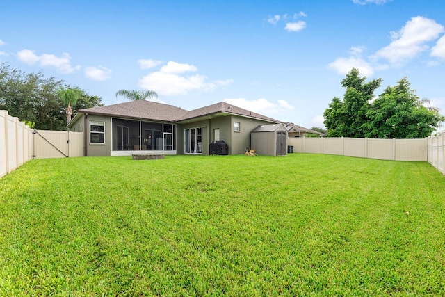 2808 Abbey Grove Dr, Valrico, FL 33594 - back of property with a sunroom, a storage unit, a fenced backyard, a gate, and stucco siding