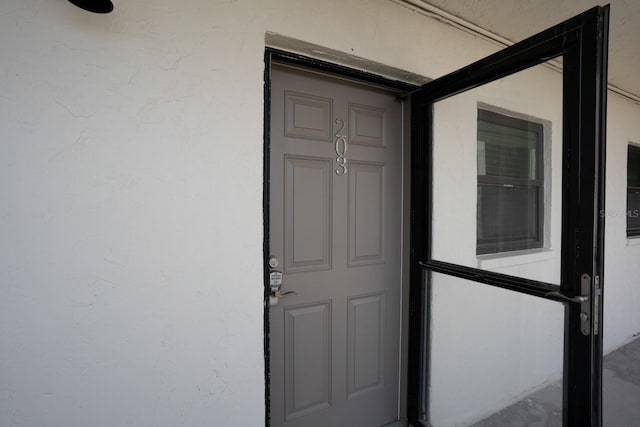18650 Gulf Blvd Unit 203, Indian Shores, FL 33785 - view of exterior entry with stucco siding