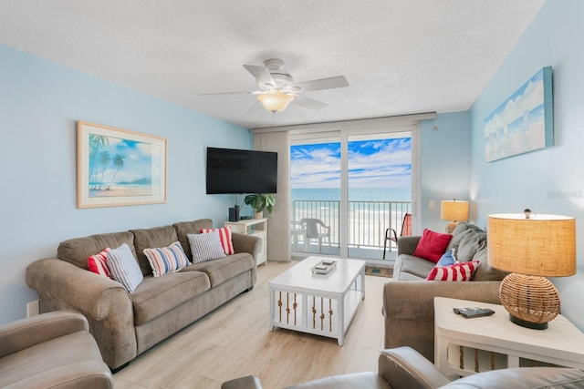 18650 Gulf Blvd Unit 203, Indian Shores, FL 33785 - living room with ceiling fan, light wood-type flooring, and a wall of windows