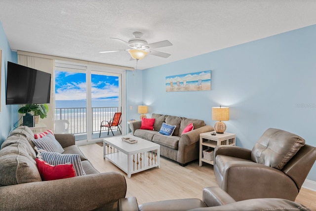 18650 Gulf Blvd Unit 203, Indian Shores, FL 33785 - living area with light wood finished floors, ceiling fan, and a textured ceiling
