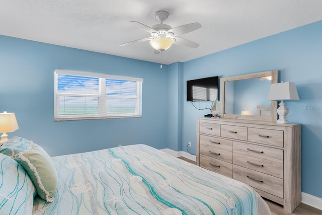 18650 Gulf Blvd Unit 203, Indian Shores, FL 33785 - bedroom with baseboards, a ceiling fan, and light wood-style floors