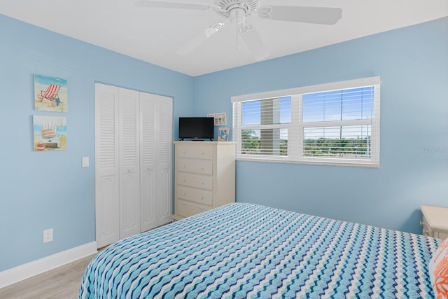 18650 Gulf Blvd Unit 203, Indian Shores, FL 33785 - bedroom featuring wood finished floors, a closet, baseboards, and a ceiling fan