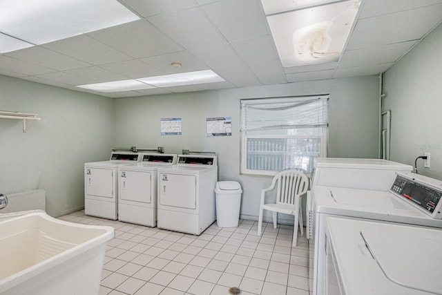 18650 Gulf Blvd Unit 203, Indian Shores, FL 33785 - community laundry with washer and clothes dryer and light tile patterned floors