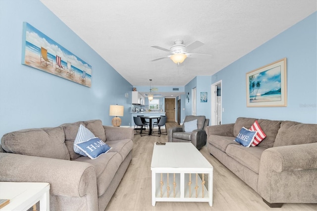 18650 Gulf Blvd Unit 203, Indian Shores, FL 33785 - living area featuring light wood finished floors and ceiling fan