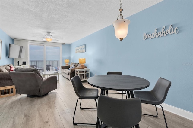 18650 Gulf Blvd Unit 203, Indian Shores, FL 33785 - dining room featuring a textured ceiling, light wood-style floors, and ceiling fan