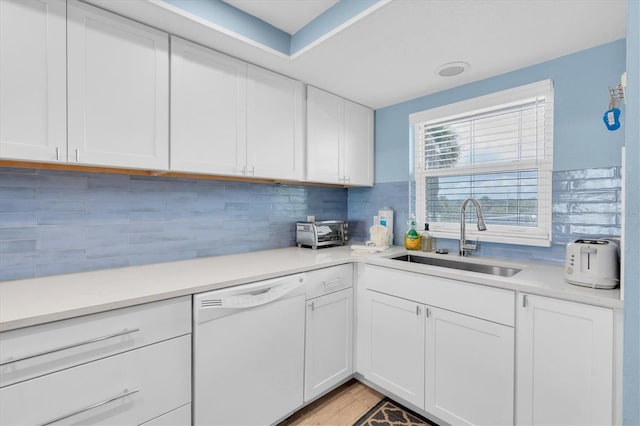 18650 Gulf Blvd Unit 203, Indian Shores, FL 33785 - kitchen featuring white dishwasher, light countertops, white cabinetry, and tasteful backsplash