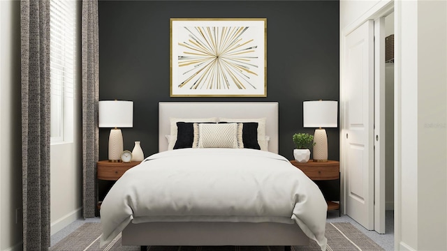 bedroom featuring light carpet and baseboards