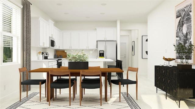 kitchen featuring white cabinets, light countertops, stainless steel appliances, and baseboards