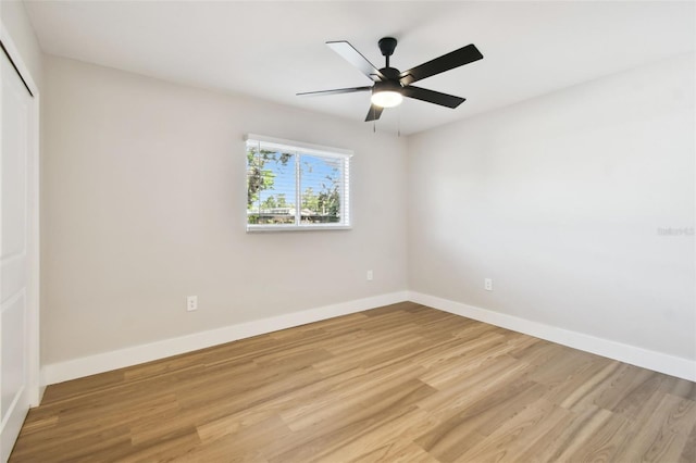 unfurnished bedroom featuring a closet, light wood-style floors, baseboards, and ceiling fan