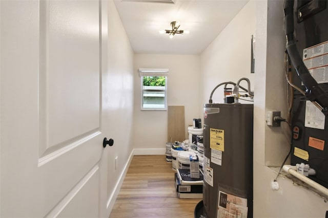 utility room with electric water heater and heating unit