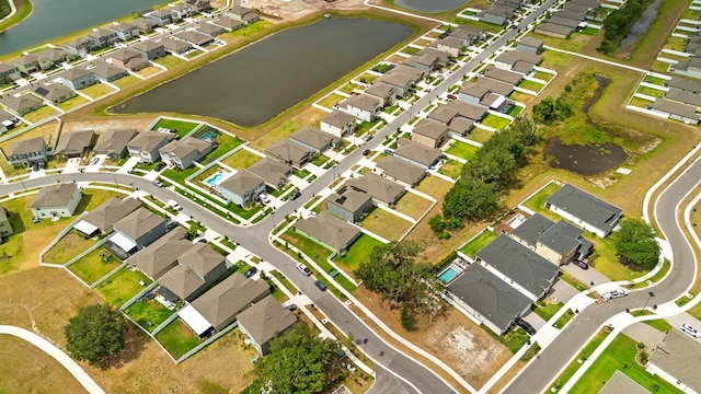 drone / aerial view with a water view and a residential view