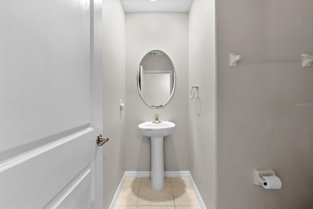 bathroom featuring a sink, tile patterned flooring, and baseboards