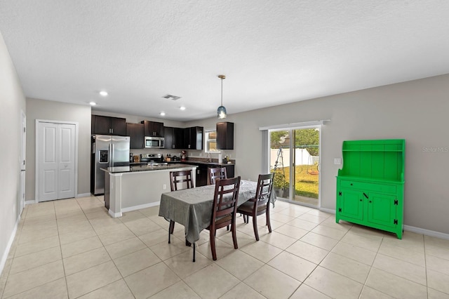 dining area with recessed lighting, a textured ceiling, baseboards, light tile patterned flooring, and visible vents