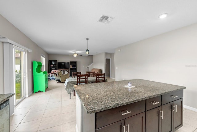 kitchen featuring dark stone counters, a ceiling fan, visible vents, and light tile patterned flooring