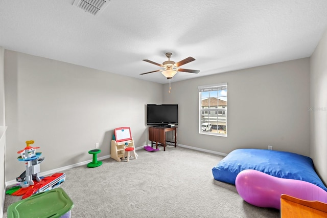 game room with ceiling fan, carpet floors, baseboards, and visible vents
