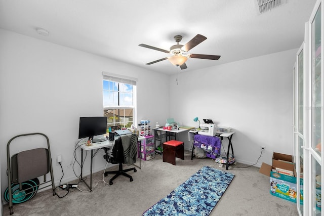 office space featuring carpet, a ceiling fan, and visible vents