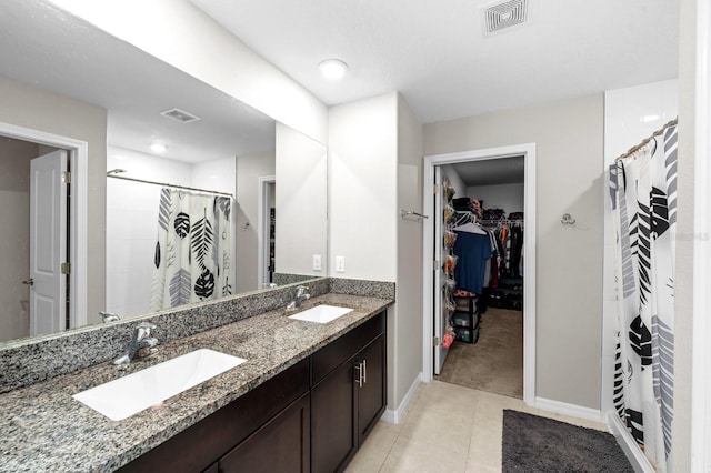 bathroom featuring visible vents, baseboards, and a sink