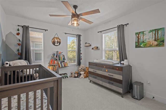 bedroom featuring ceiling fan and carpet