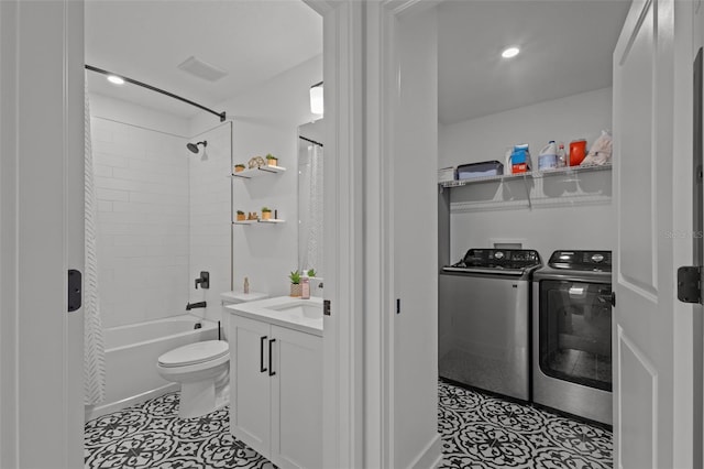 bathroom with toilet, vanity, tile patterned floors, shower / bath combo, and washer and dryer