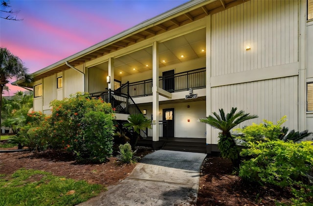 exterior entry at dusk with a balcony