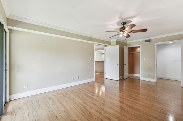 unfurnished bedroom with ornamental molding, light wood-style flooring, baseboards, and a ceiling fan