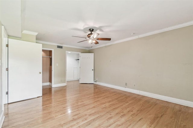 unfurnished bedroom featuring light wood-style flooring, crown molding, baseboards, and ceiling fan
