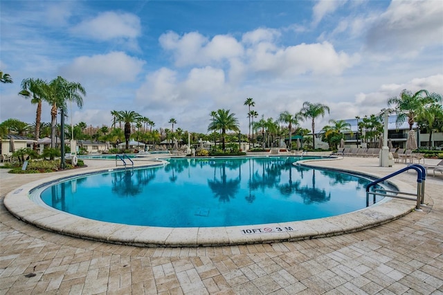 community pool with a patio area