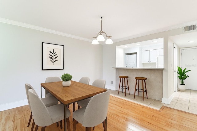 4946 Mill Pond Rd Unit 3180, Wesley Chapel, FL 33543 - dining room with washer / dryer, crown molding, light wood finished floors, and recessed lighting