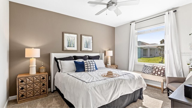 carpeted bedroom with baseboards and ceiling fan