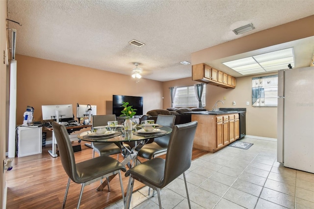 8531 Woodcrest Dr, Port Richey, FL 34668 - dining space with a ceiling fan, a textured ceiling, and light tile patterned floors