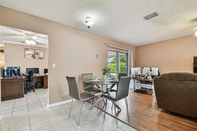8531 Woodcrest Dr, Port Richey, FL 34668 - tiled dining area with an office area, ceiling fan, a textured ceiling, and baseboards