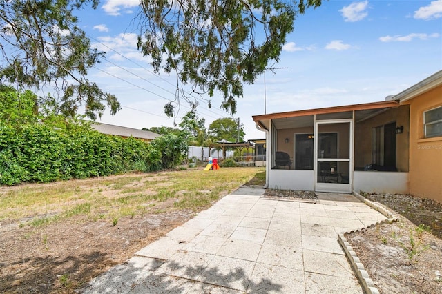 8531 Woodcrest Dr, Port Richey, FL 34668 - view of yard featuring a sunroom, a playground, and a patio area