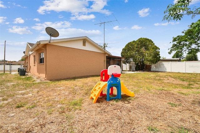 8531 Woodcrest Dr, Port Richey, FL 34668 - back of house with a sunroom and stucco siding