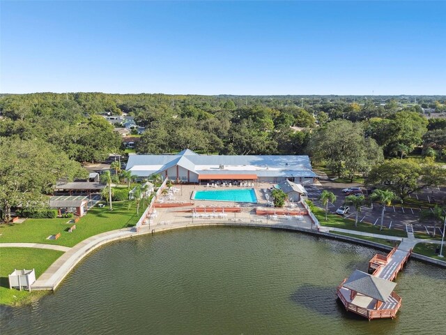 8531 Woodcrest Dr, Port Richey, FL 34668 - bird's eye view of a heavily wooded area, a nearby body of water, and a pool