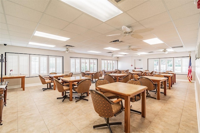 8531 Woodcrest Dr, Port Richey, FL 34668 - dining area featuring a paneled ceiling, light tile patterned floors, baseboards, and ceiling fan