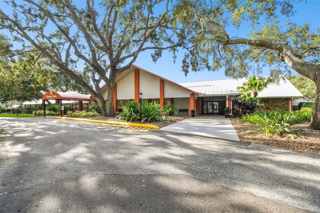 8531 Woodcrest Dr, Port Richey, FL 34668 - view of front of home featuring metal roof and a carport