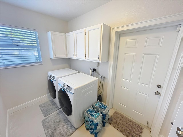 4715 W Chapin Ave, Tampa, FL 33611 - laundry room with cabinet space, separate washer and dryer, and baseboards