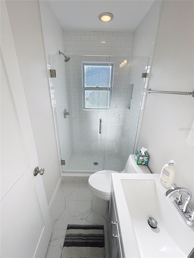4715 W Chapin Ave, Tampa, FL 33611 - bathroom featuring marble finish flooring, a shower stall, toilet, and baseboards