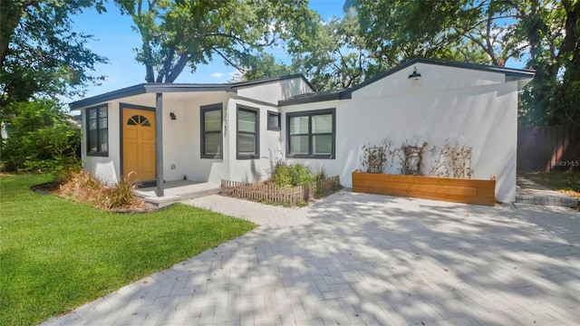 1715 N Alexander Rd, Tampa, FL 33603 - view of front of home featuring a front yard and stucco siding