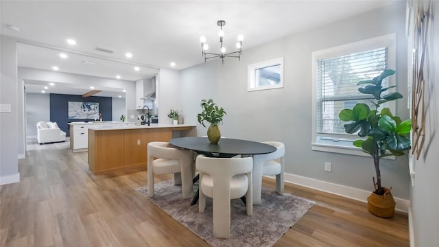 1715 N Alexander Rd, Tampa, FL 33603 - dining area with visible vents, baseboards, light wood finished floors, a notable chandelier, and recessed lighting