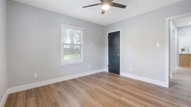 1715 N Alexander Rd, Tampa, FL 33603 - unfurnished bedroom featuring a ceiling fan, baseboards, and light wood-style flooring