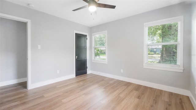 1715 N Alexander Rd, Tampa, FL 33603 - unfurnished bedroom with baseboards, ceiling fan, and light wood-style flooring