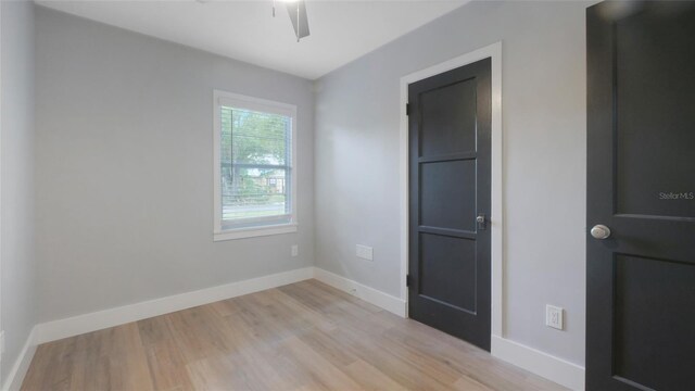 1715 N Alexander Rd, Tampa, FL 33603 - spare room with baseboards, a ceiling fan, and light wood-style flooring
