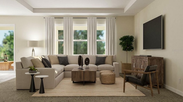 living area with a tray ceiling, plenty of natural light, baseboards, and carpet floors