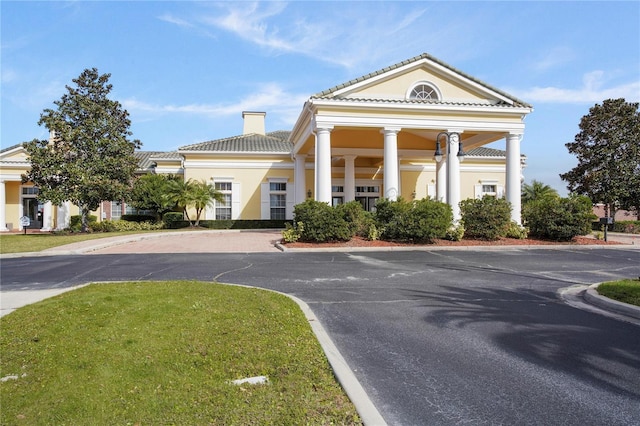 view of building exterior with curved driveway