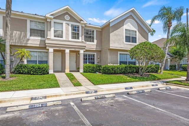 732 Kensington Lake Cir, Brandon, FL 33511 - view of property featuring stucco siding, uncovered parking, and a front yard