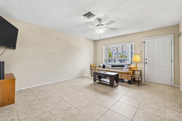 732 Kensington Lake Cir, Brandon, FL 33511 - living room with a ceiling fan, a textured ceiling, tile patterned flooring, and baseboards